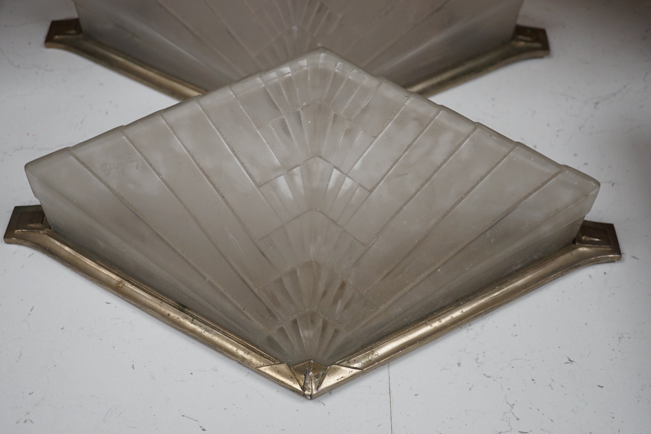Two Art Deco wall lights with chrome frames by Degue, 40cm wide. Condition - fair, requires re wiring.